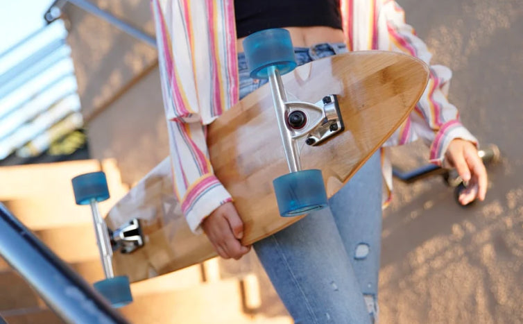 A girl holding skateboard